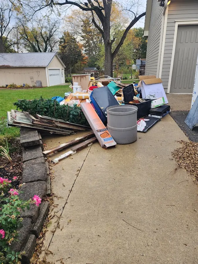 Dumpster being loaded with debris for Roofing Dumpster Rental in Clarinda